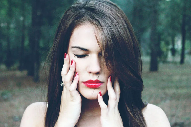 Woman with red manicured nails